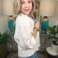 Woman in white linen jacket