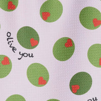 Patterned fabric with green circles and red hearts on a light pink background, featuring the text 'olive you'.