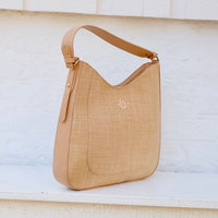 Beige handbag with a brand logo on a light background
