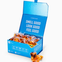 Blue box of laundry detergent pods with text 'Smell Good, Look Good, Feel Good' on a white background