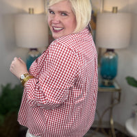 Woman wearing a red gingham button down top