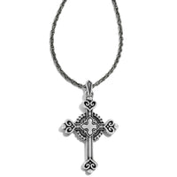 Silver cross pendant necklace on a white background