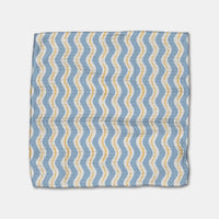 Dishcloth with blue and yellow wavy pattern on a white background