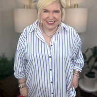 Woman wearing a blue and white striped top