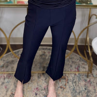 Navy blue pants with a front seam and subtle front slit detail.