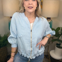 Woman in light blue linen jacket