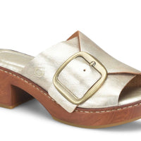 A single women's heeled slide sandal with a metallic champagne-gold leather upper, a large square buckle, and a brown wooden platform block heel, shown on a white background.