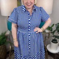 Woman wearing a blue and white checkered maxi dress.