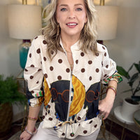 Woman modeling a jacket with puppies and polka dots patterned on it