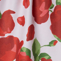 Close-up of fabric with red floral pattern on a white background