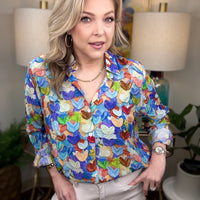 Woman wearing a colorful heart print blouse