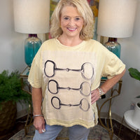 Cream colored oversized t-shirt with lined graphic applique with horsebit pattern
