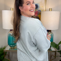 Woman wearing a dusty blue american flag shirt.