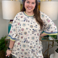 Woman in a floral waffle knit dress.
