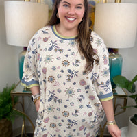 Woman in a floral waffle knit dress.