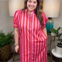 Woman wearing a red and pink striped maxi dress.