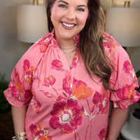 Woman wearing a pink floral blouse
