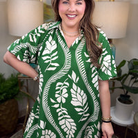 Woman wearing a green and white patterned dress