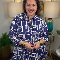 Woman wearing a blue and white geometric patterned shirt