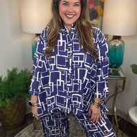 Woman wearing a blue and white geometric patterned shirt and pants
