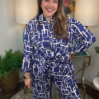 Woman wearing a blue and white geometric patterned shirt and pants