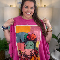 woman wearing a sleeveless bright pink top with a large colorful Frida Kahlo graphic print on the front
