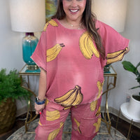 Woman in pink linen pants with a banana print all over