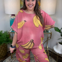 Woman in pink linen pants with a banana print all over