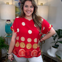 Woman in a red top with polka dots on it