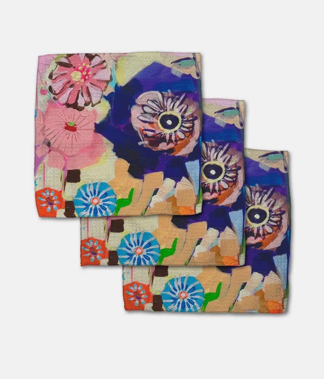 Set of colorful floral towels on a white background