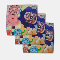 Set of colorful floral towels on a white background
