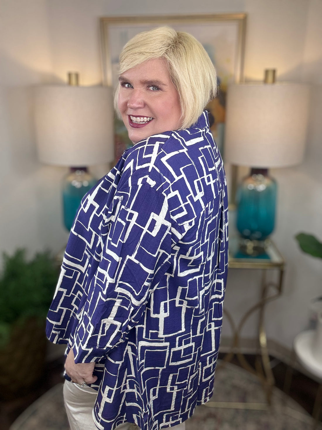 Woman wearing a blue and white geometric patterned shirt