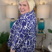 Woman wearing a blue and white geometric patterned shirt