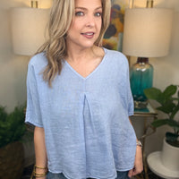 Woman wearing blue linen top