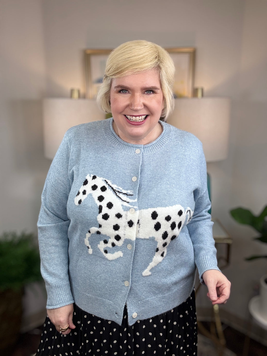 Light blue cardigan with white horse and black spots