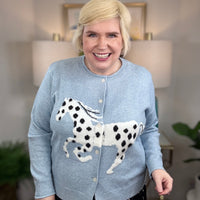 Light blue cardigan with white horse and black spots