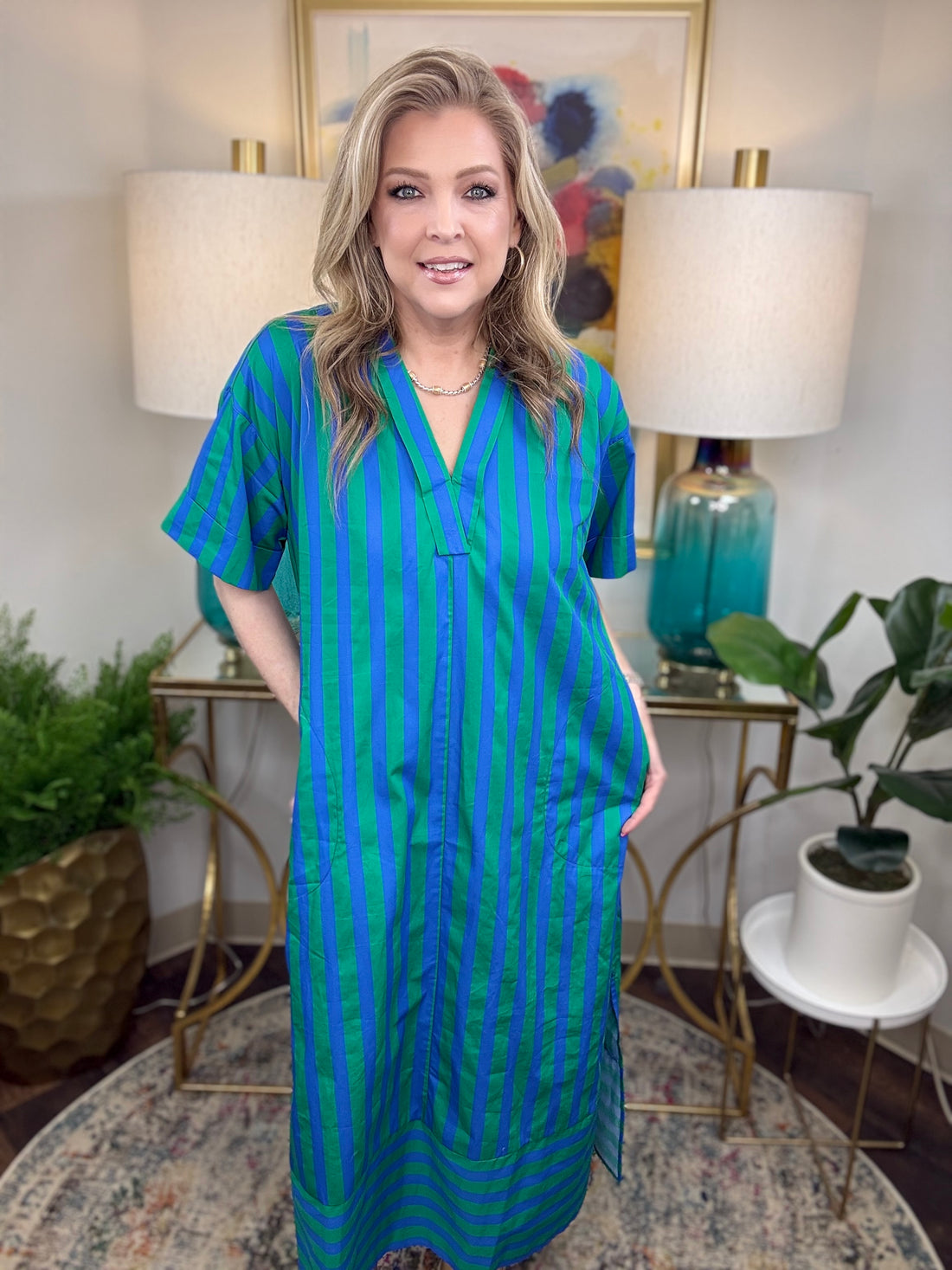 Woman wearing a blue and green striped dress