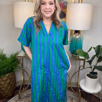 Woman wearing a blue and green striped dress