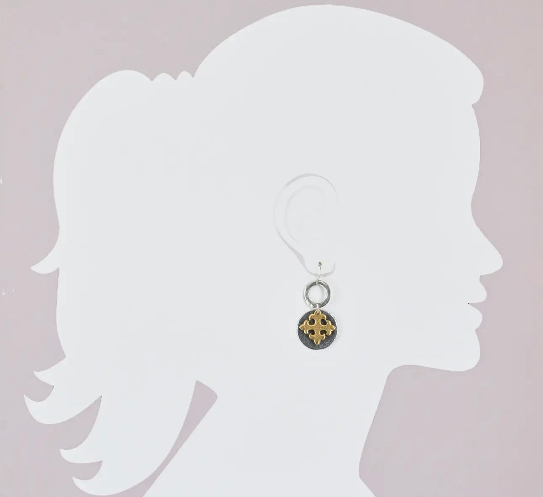 Earring displayed on a white silhouette against a light gray background