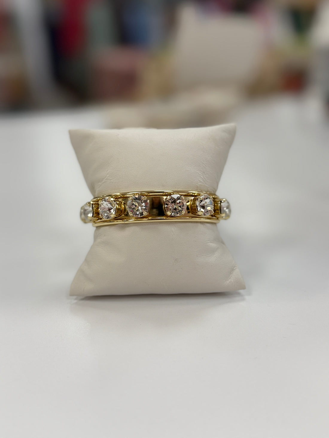 Gold cuff bracelet with clear diamond stones