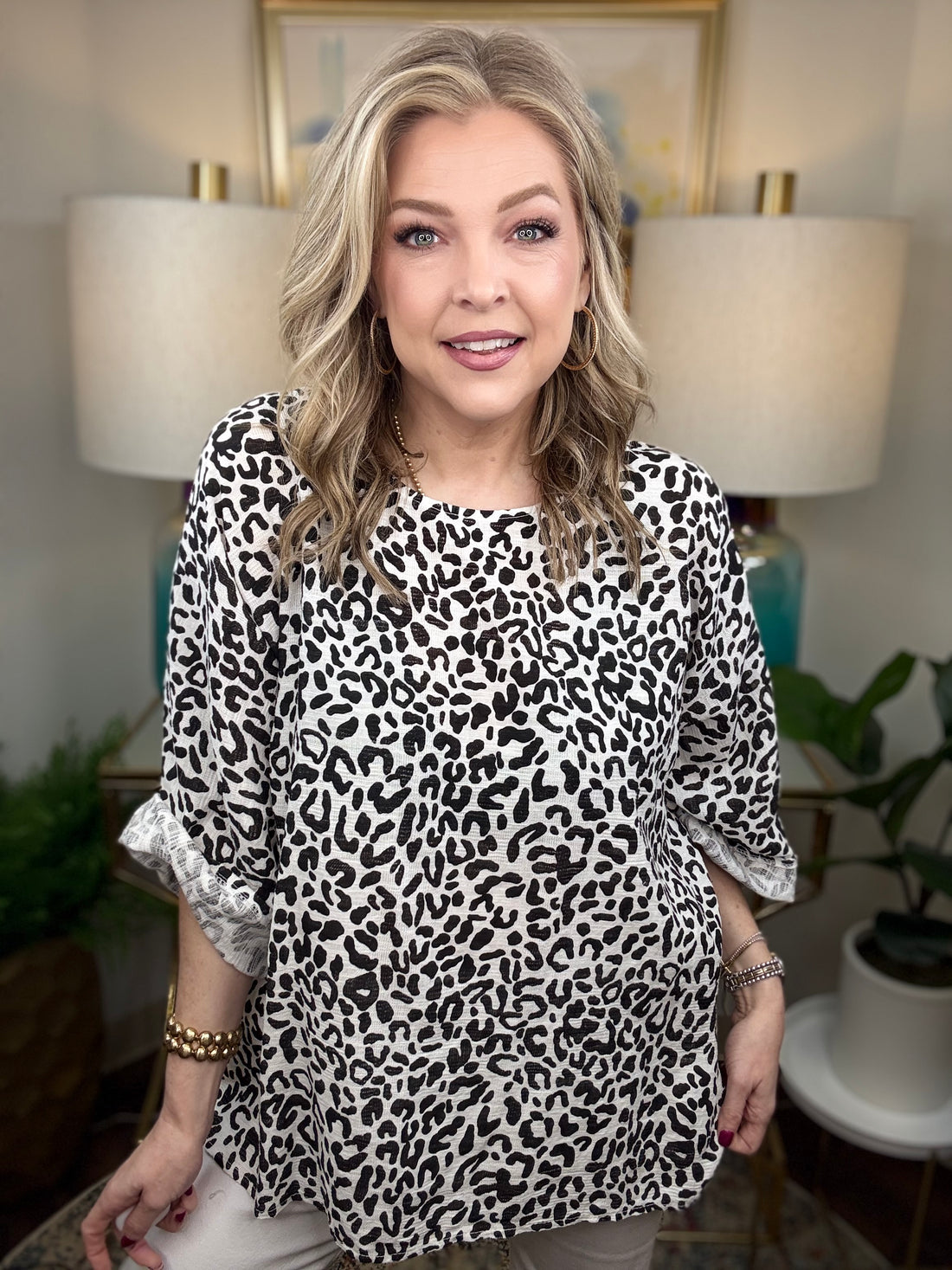Woman wearing a white leopard print top