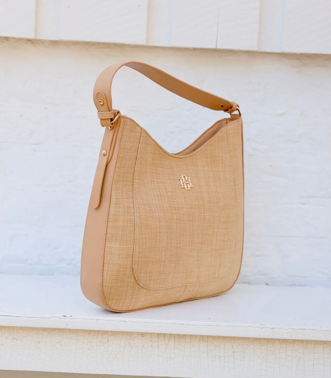 Beige handbag with a brand logo on a light background
