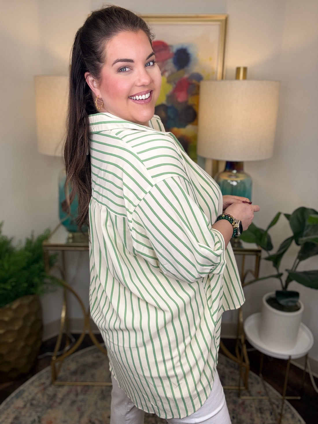 Woman wearing a green and cream striped top