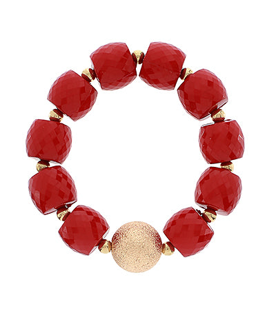 Red beaded bracelet with a gold accent on a white background