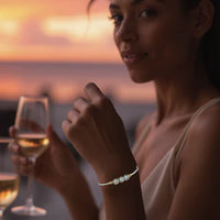 Woman wearing a Sterling Silver Filled bracelet with Sterling Silver Setting, 3 circular CZ stones, 14K Gold Filled wire wrap