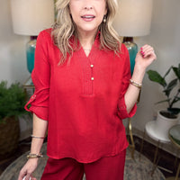 Women’s red matching set with gold button details