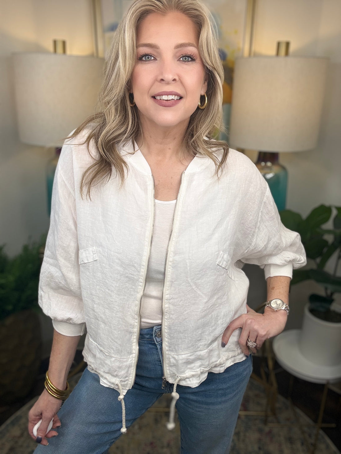 Woman in white linen jacket.