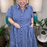 Woman wearing a blue and white checkered maxi dress.