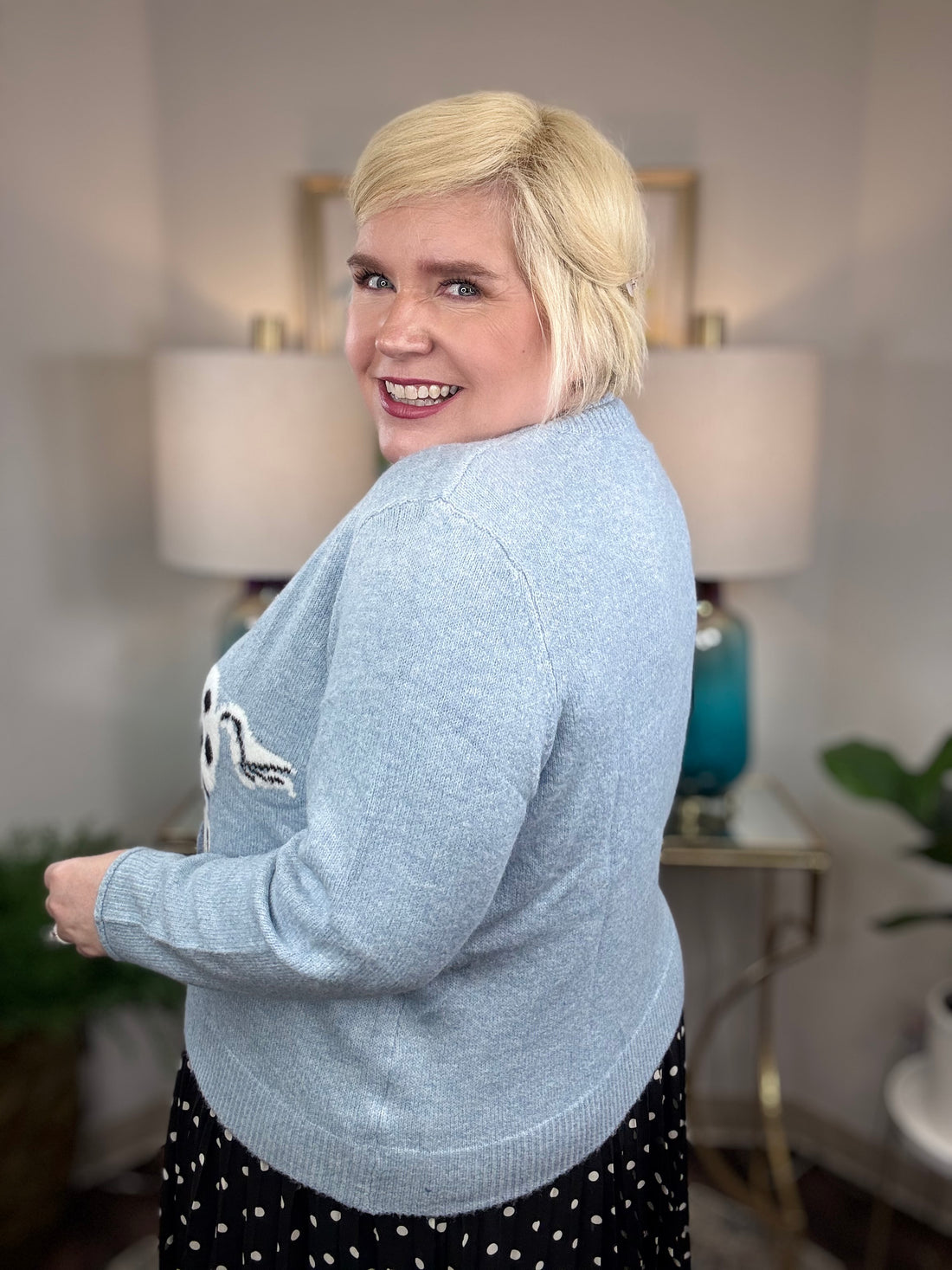 Light blue cardigan with white horse and black spots