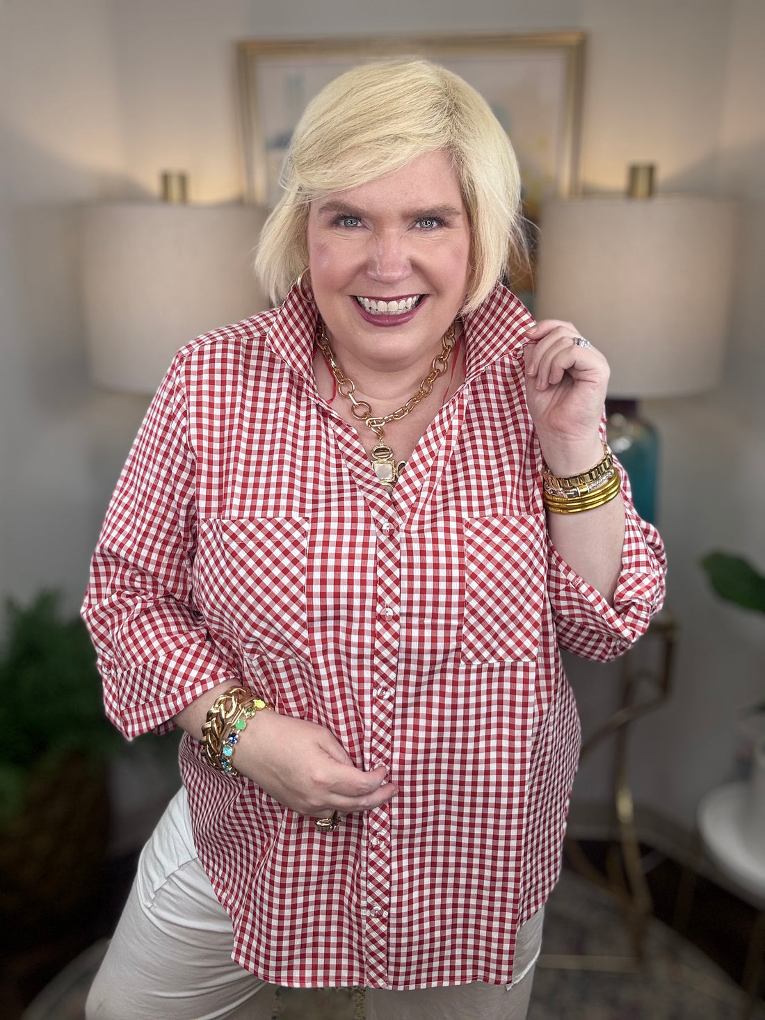 Woman wearing a red gingham button down top